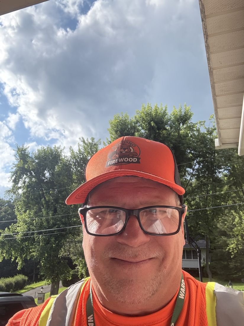 The Pocono Firewood owner wearing a Pocono Firewood cap